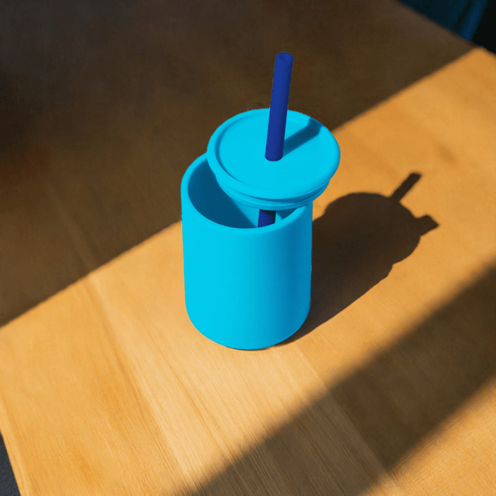 a blue cup sitting on top of a wooden table