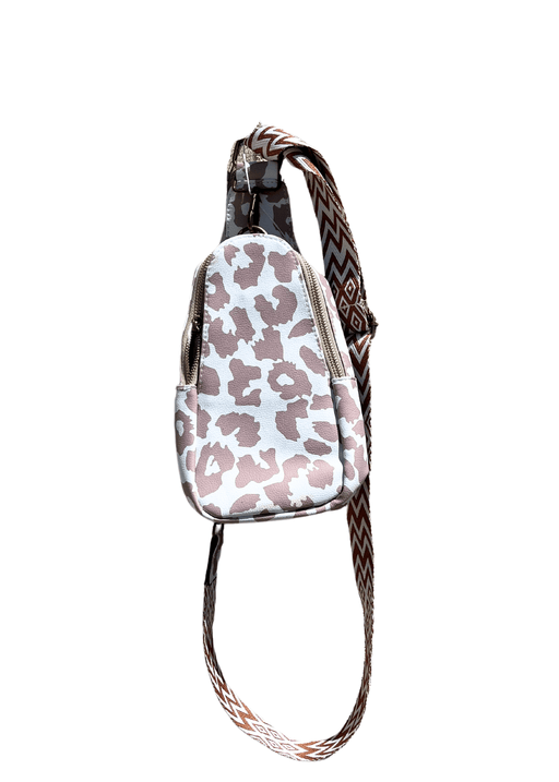 a pink and white bag with a leopard print strap