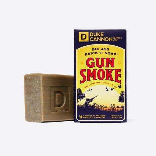 a bar of soap next to a box with the name Gun Smoke on it