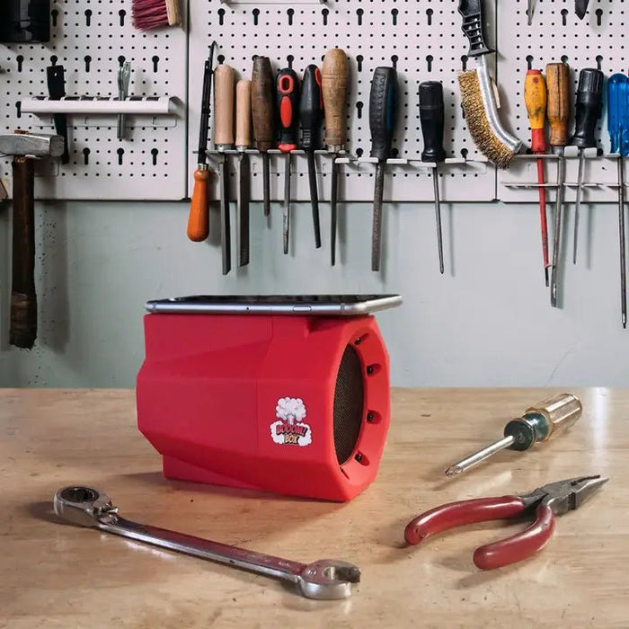 a bunch of tools that are on a table with a red speaker