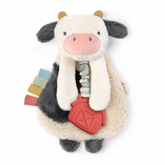 a stuffed animal baby teething toy with a tag in it's mouth