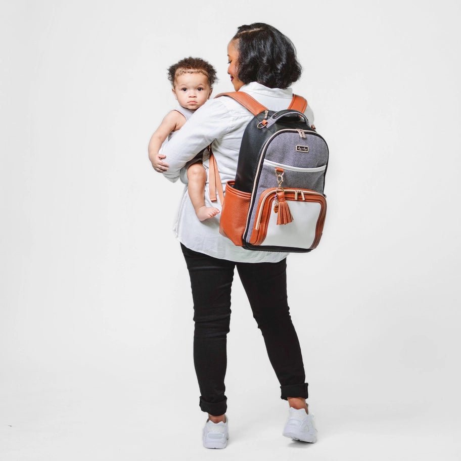 a woman holding a baby in a backpack