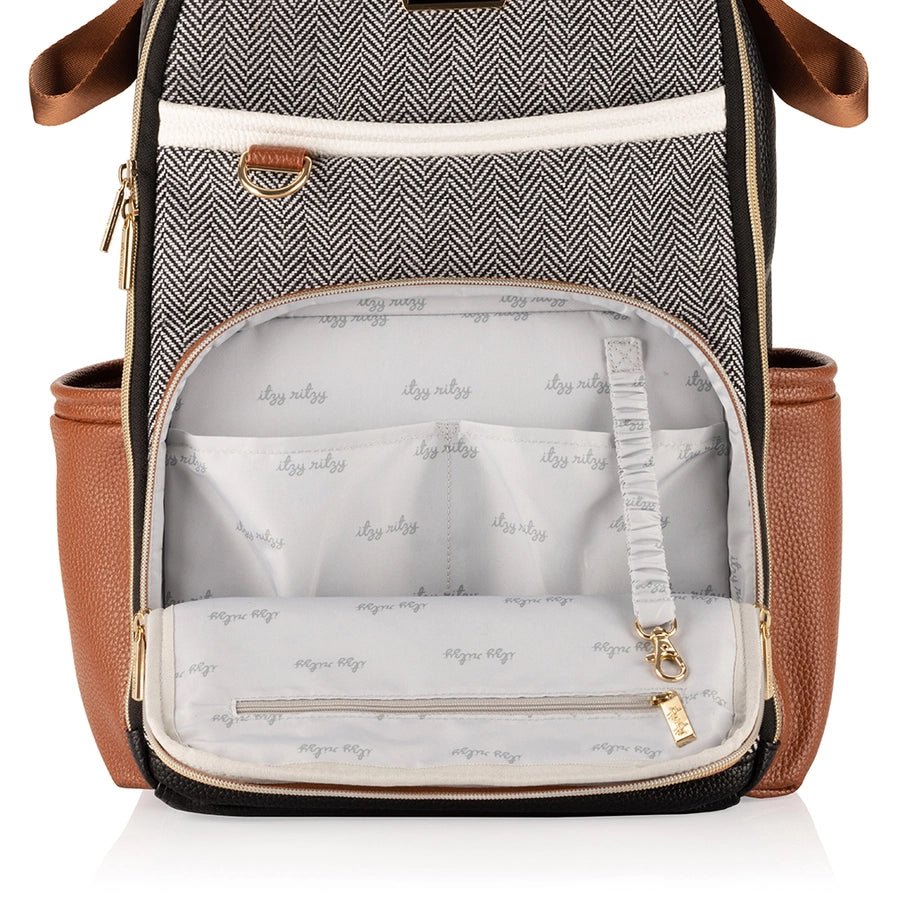 a brown and white backpack with a zippered pocket