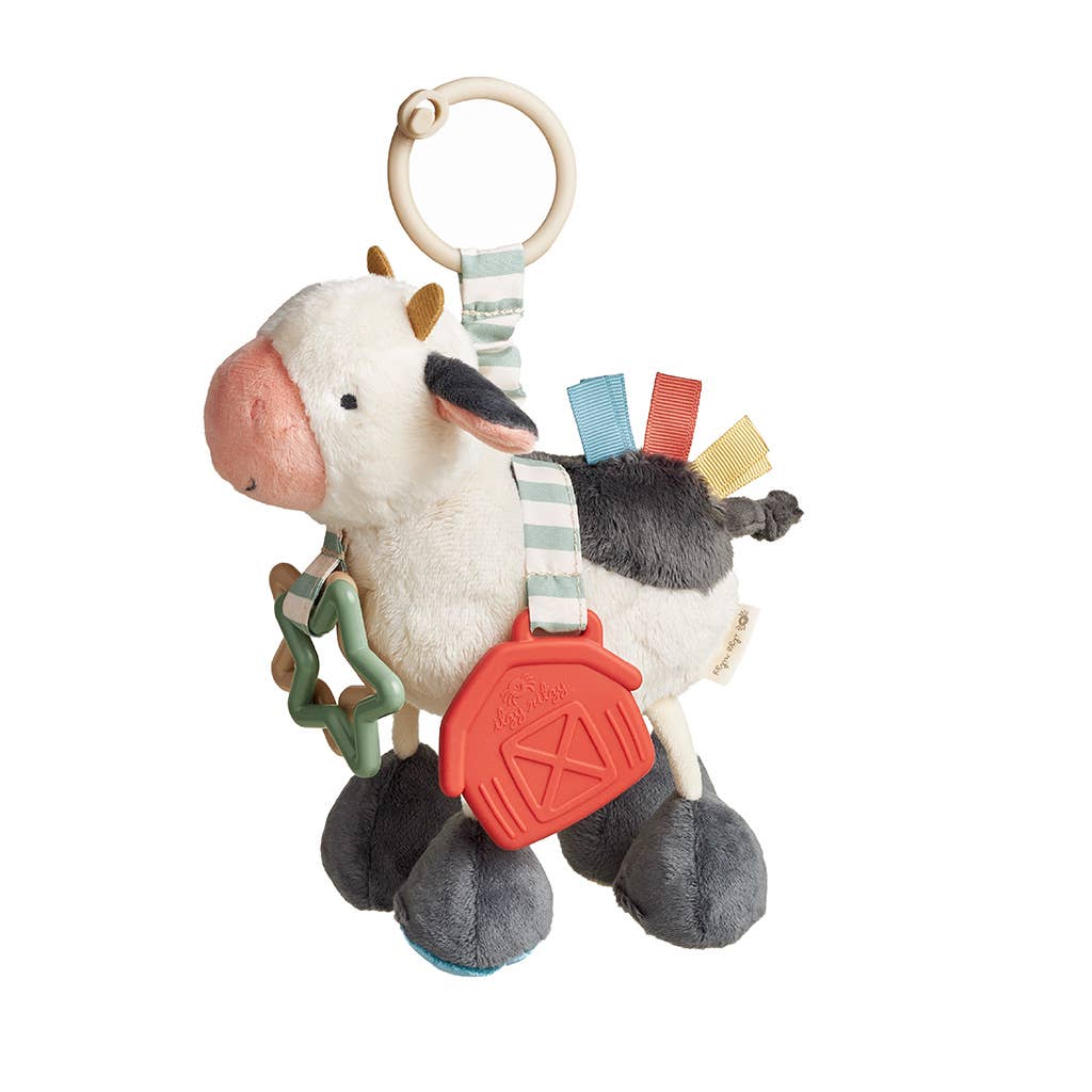 a toy cow with a tag hanging from it's back