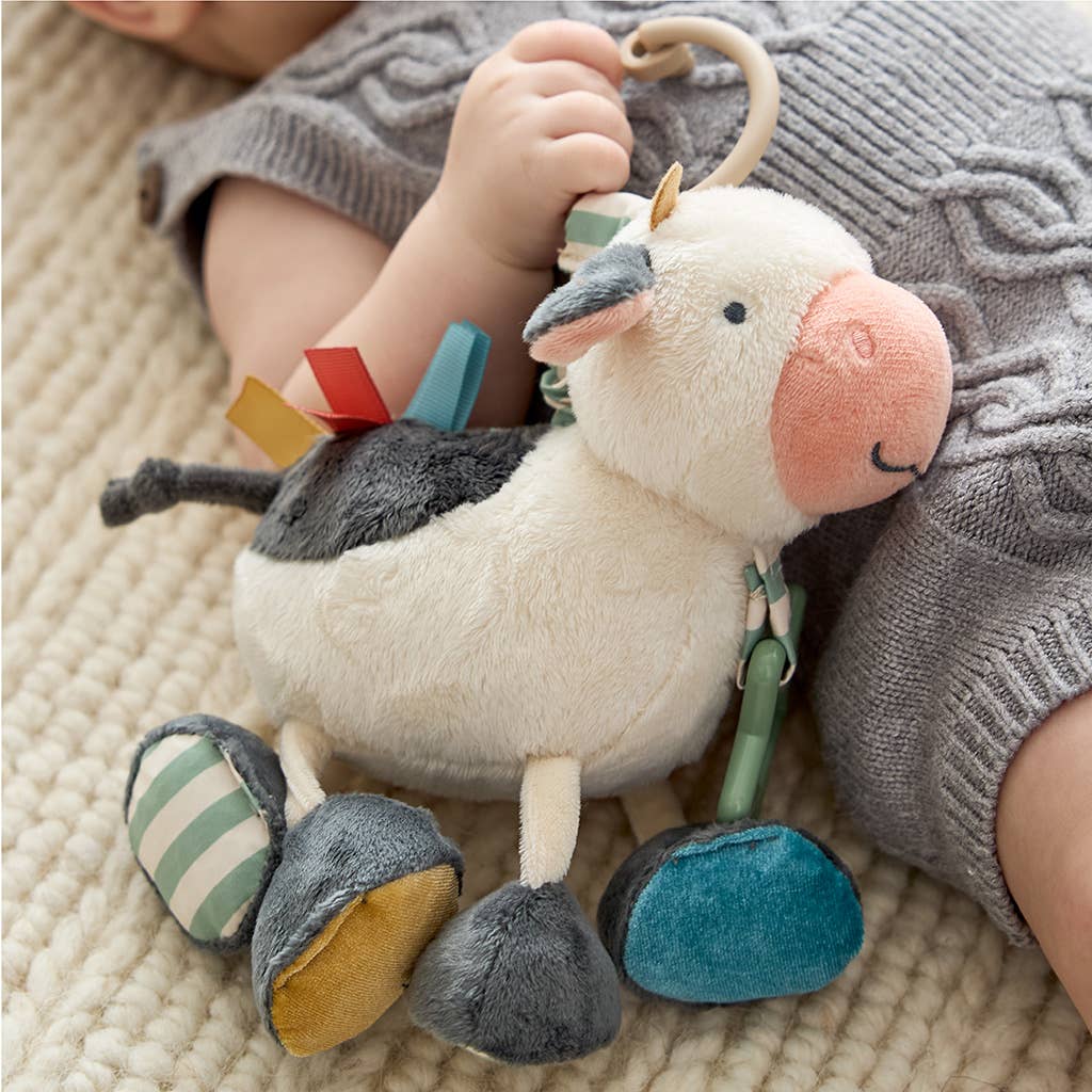 a baby laying on the floor with a stuffed animal