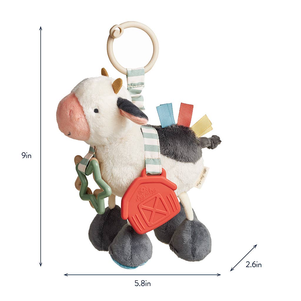 a toy cow with a tag hanging from it's back