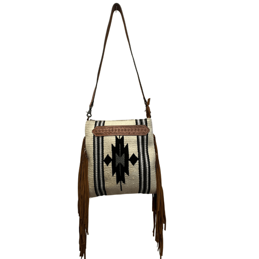 a white and black bag with a brown fringe