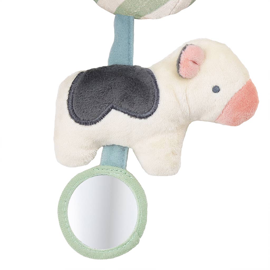 a stuffed cow hanging from a hook on a wall