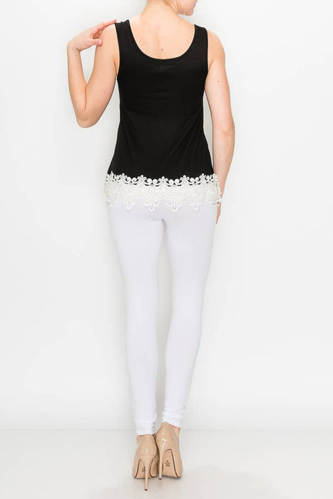 a woman wearing white pants and a black top