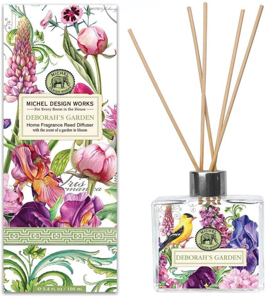 Michel Design Works Home Fragrance Reed Diffuser 'Deborah's Garden' featuring a stylish glass decanter surrounded by colorful floral illustrations on the box, perfect for adding a fragrant touch to your space.