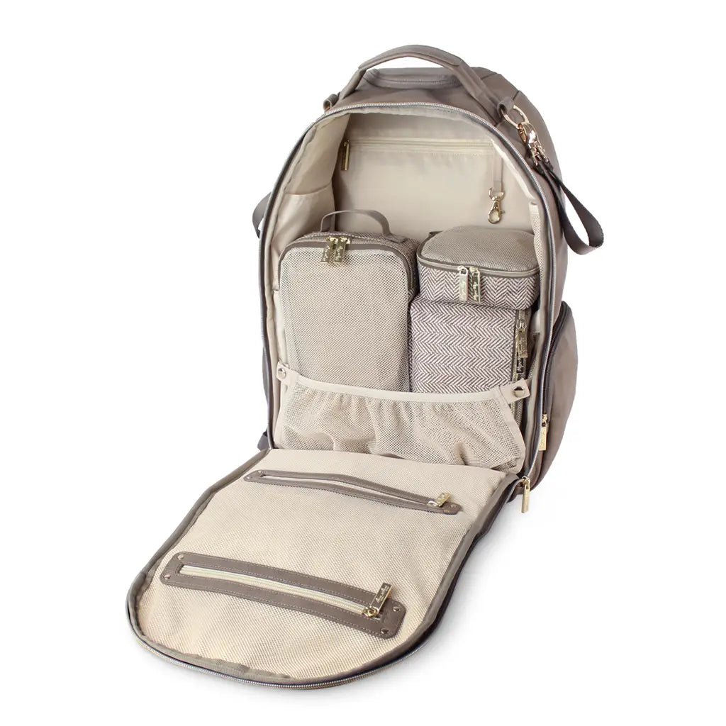 an open diaper bag with several pieces of packing cubes in it