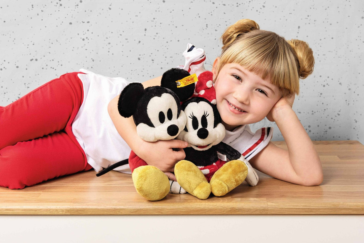 girl holding Disney's Mickey Mouse Stuffed Plush Toy, 12 Inches and minnie mouse