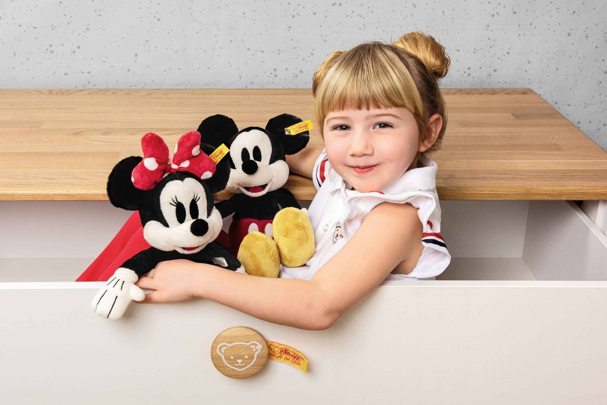 girl holding Disney's Mickey Mouse Stuffed Plush Toy, 12 Inches and minnie mouse