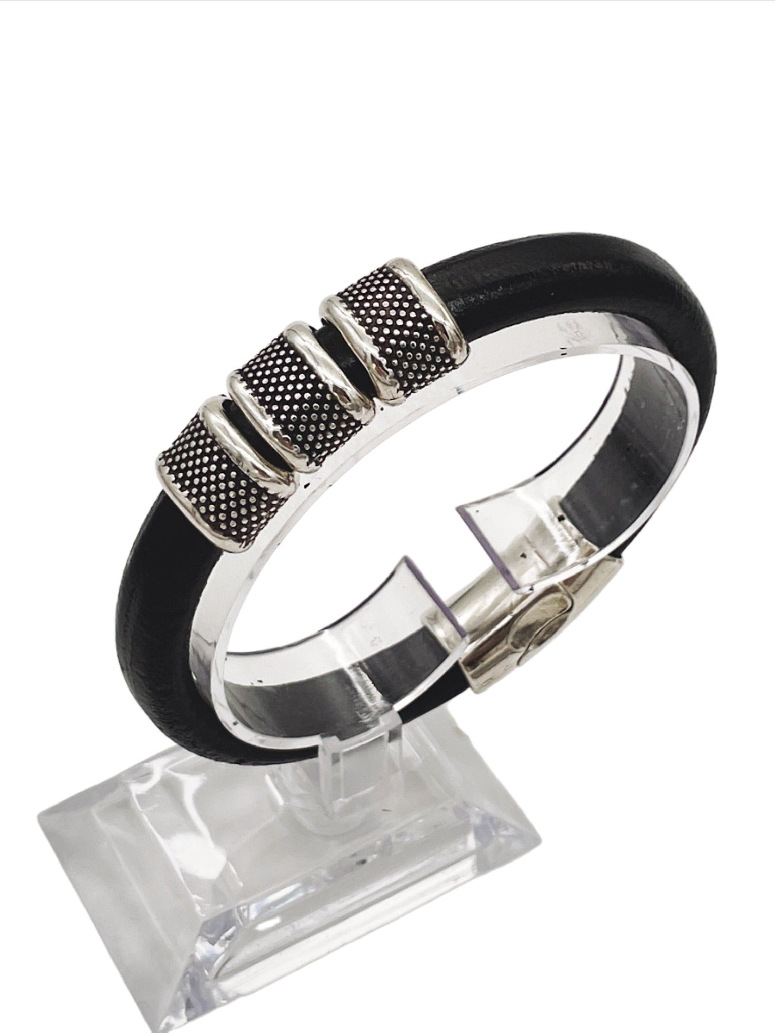 a black and silver bracelet on a stand