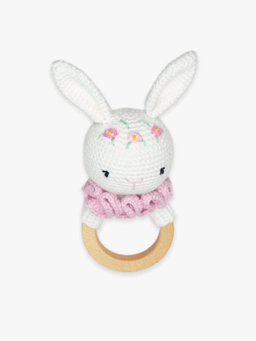 a crocheted white bunny with pink flowers on it's head