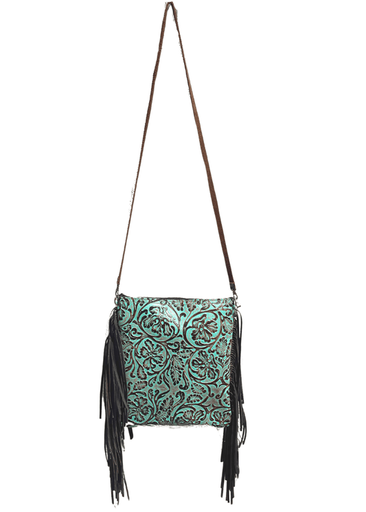 a turquoise and brown tooled leather crossbody purse with fringe hanging from it