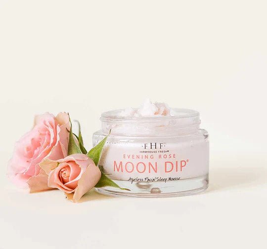 a pink rose sitting next to a jar of moon dip