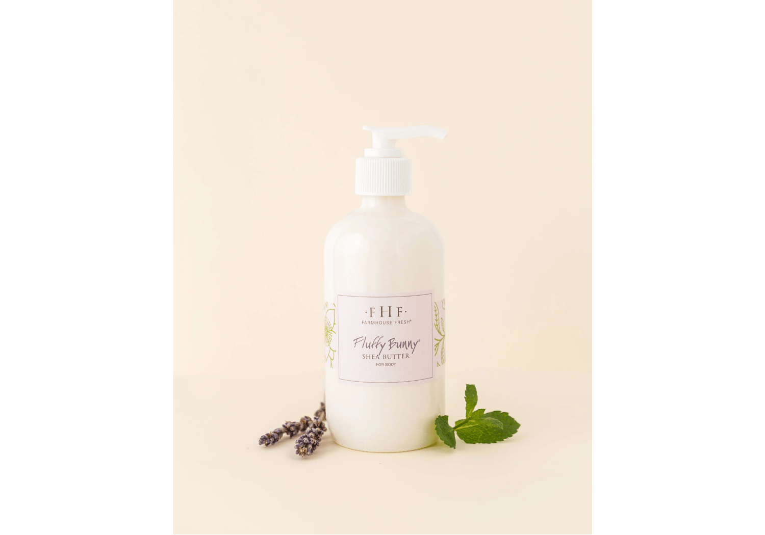 a bottle of hand lotion next to a sprig of lavender