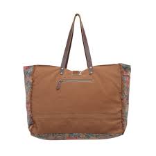 a brown handbag with a floral design on it