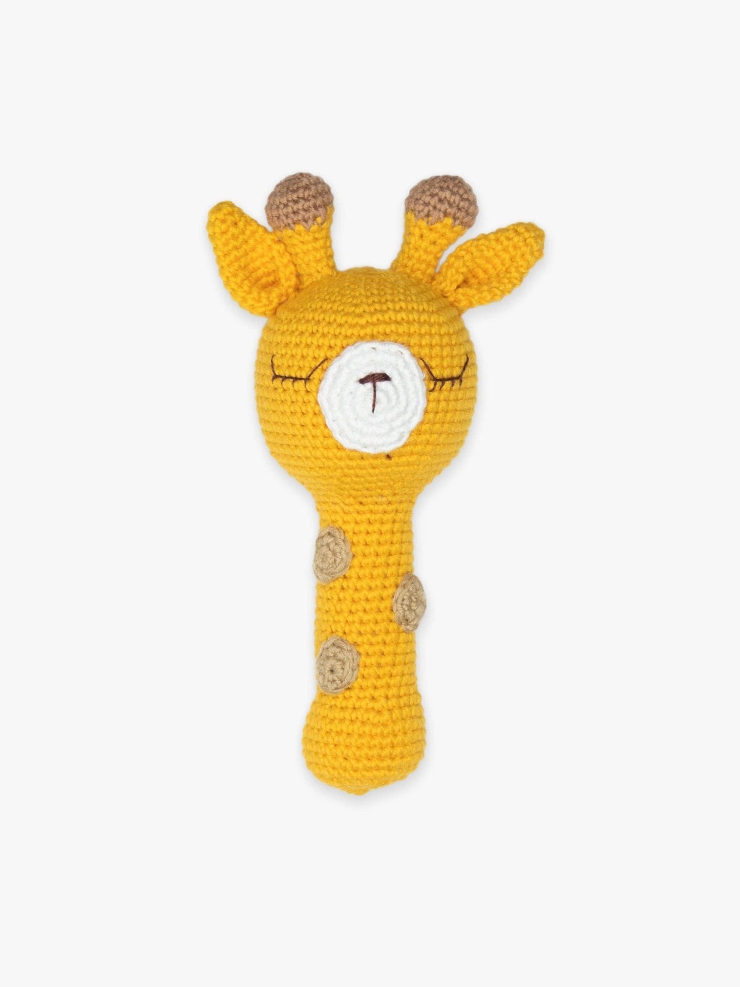 a crocheted giraffe rattle on a white background