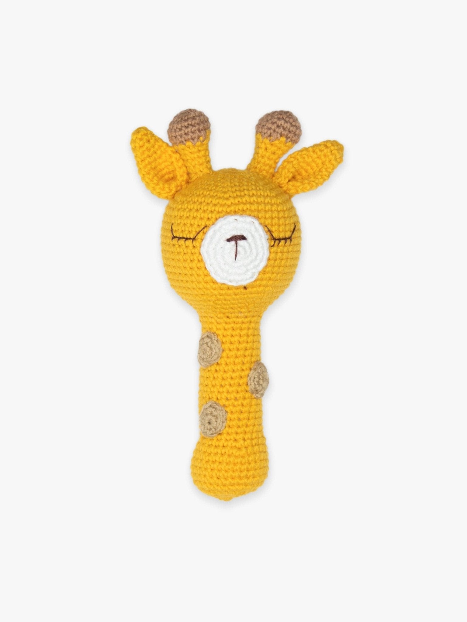 a crocheted giraffe rattle on a white background