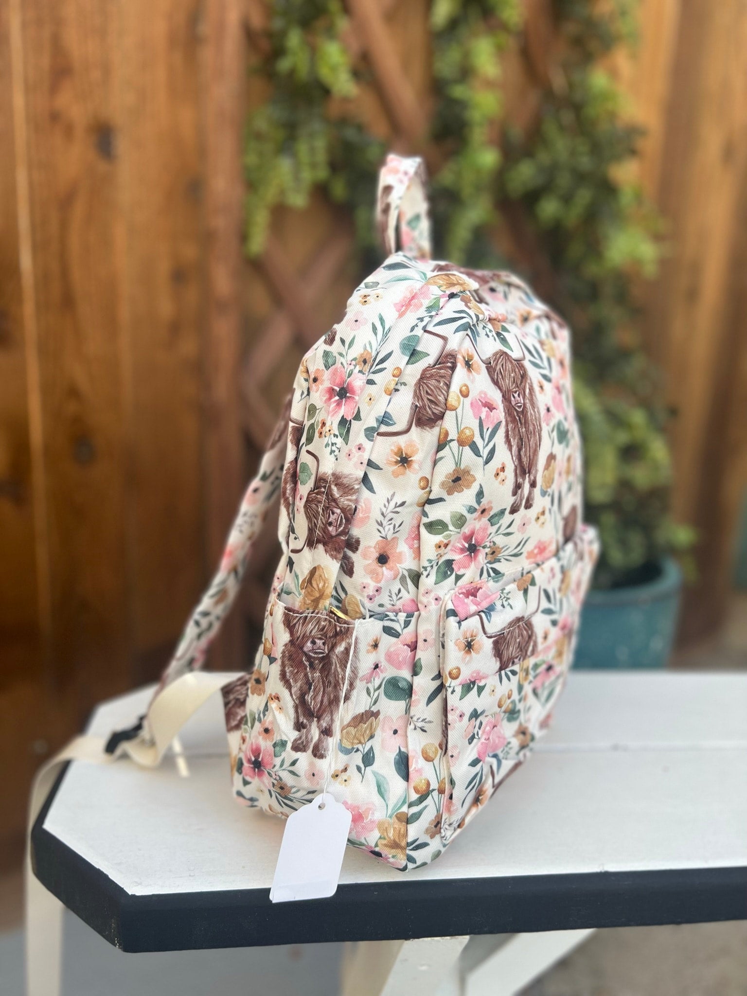 a floral backpack sitting on top of a table