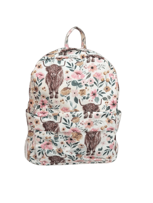 a white backpack with brown bears and flowers on it