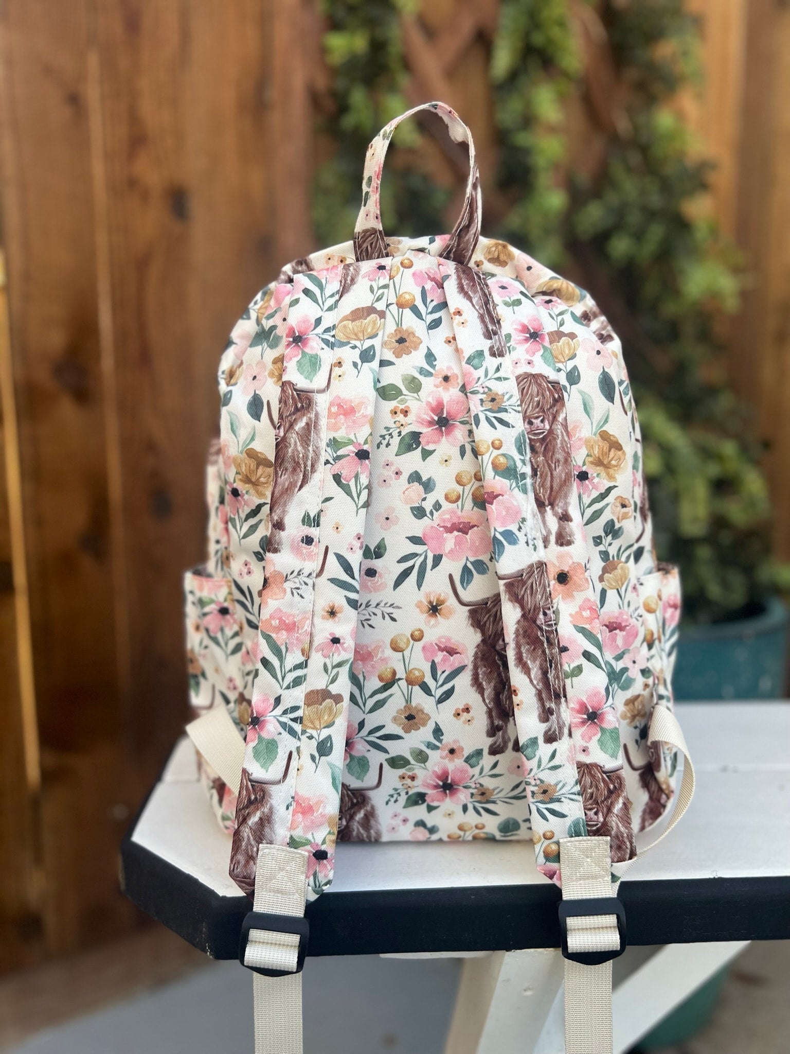 a floral backpack sitting on top of a table