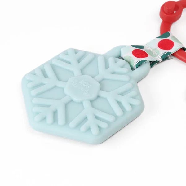 a snowflake keychain with a candy bar attached to it