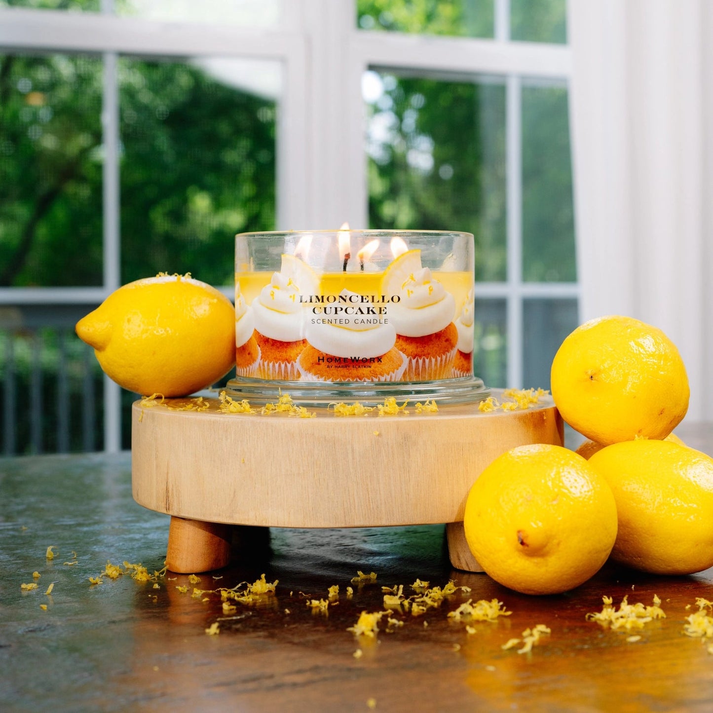 a candle with lemons around it on a table