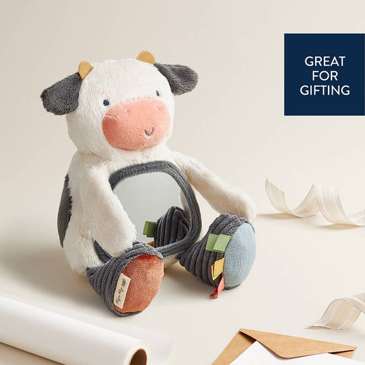 a stuffed cow sitting on top of a table