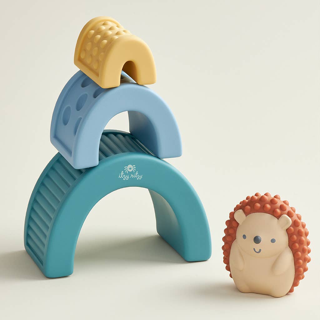 a hedgehog toy next to a toy arch