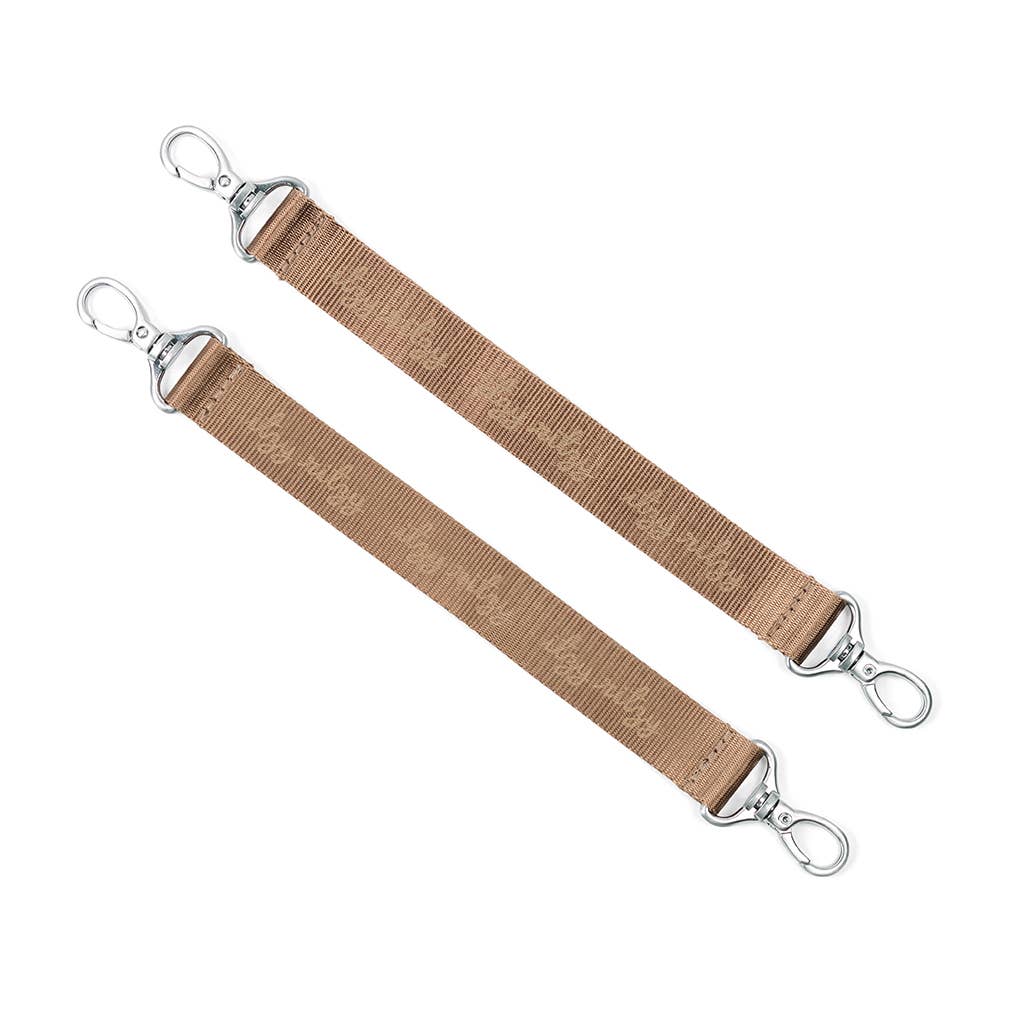 a pair of brown straps with metal hooks