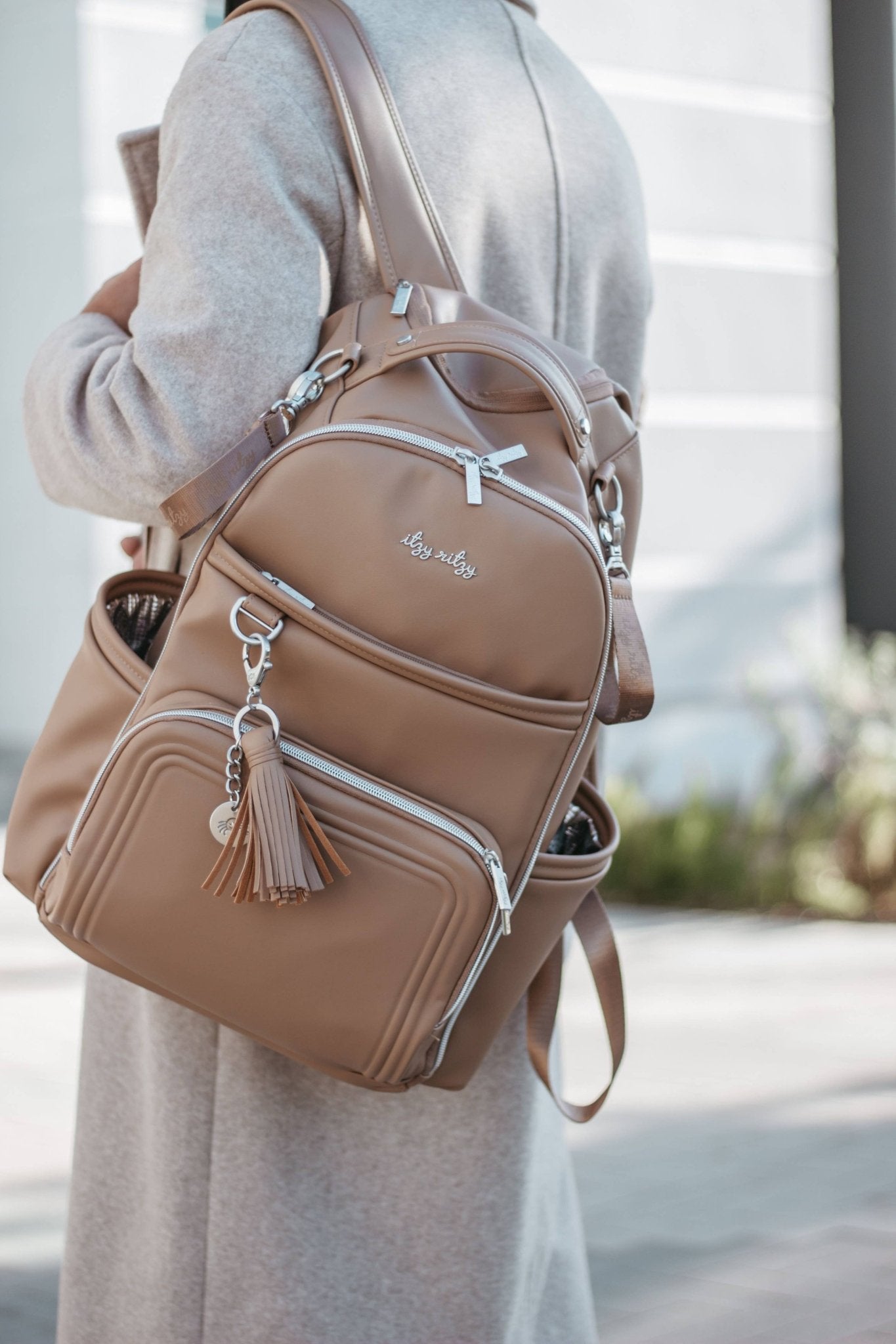 a woman carrying a brown purse on her back