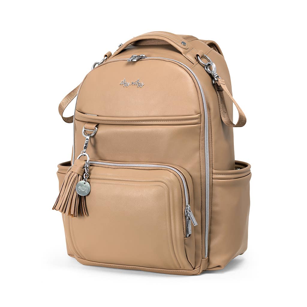 a tan backpack with a tassel on the front