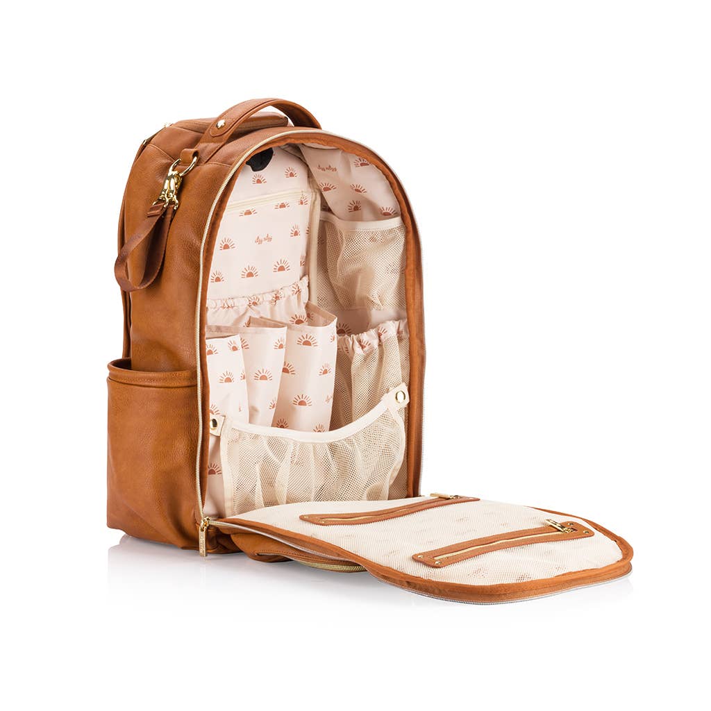 a brown leather backpack with its contents in it