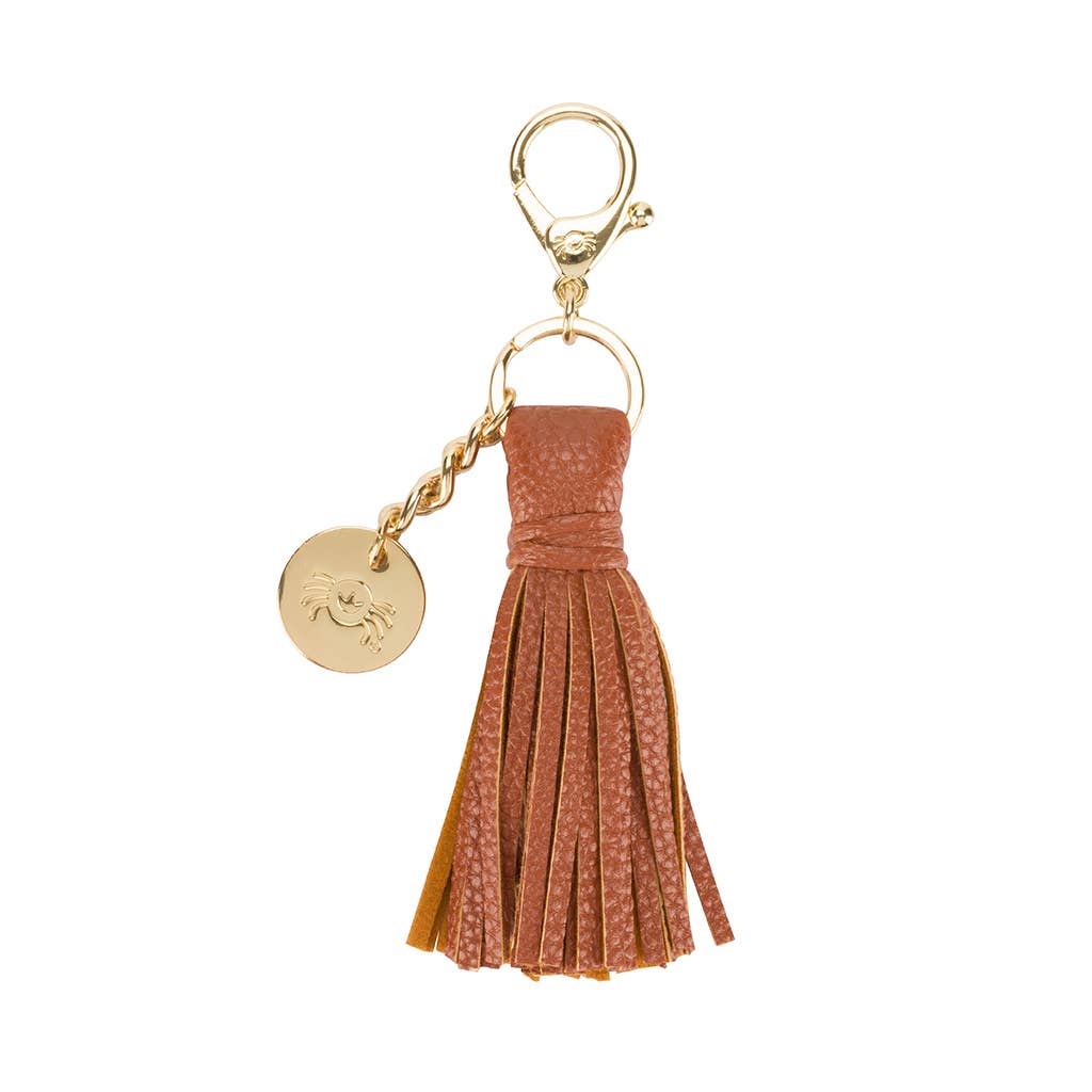 a key chain with a tassel and a medallion