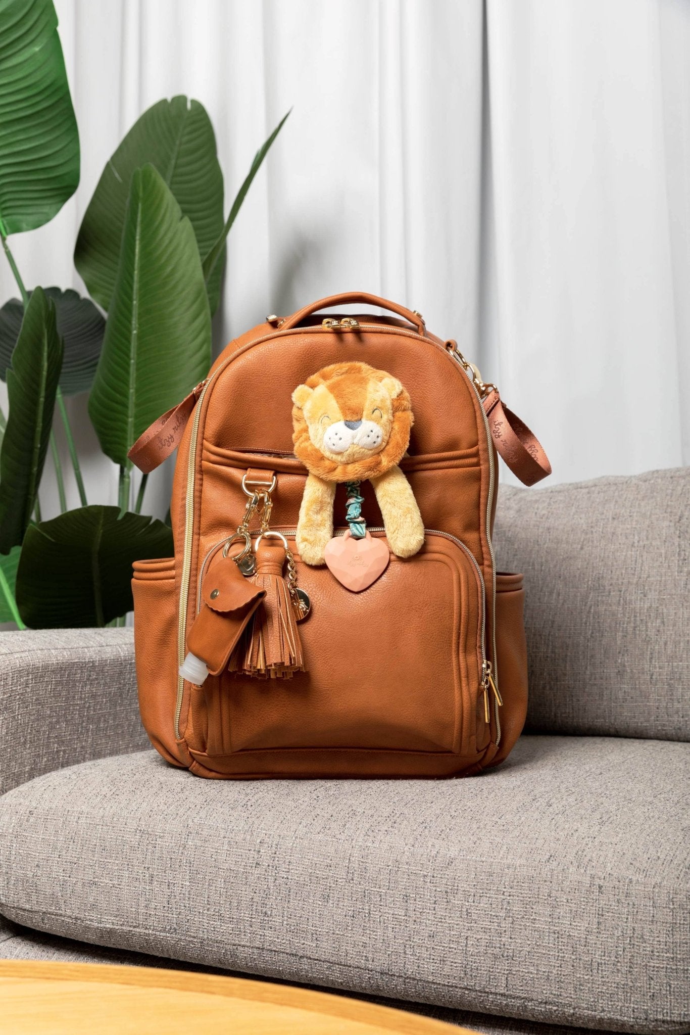 a brown backpack with a stuffed animal on it