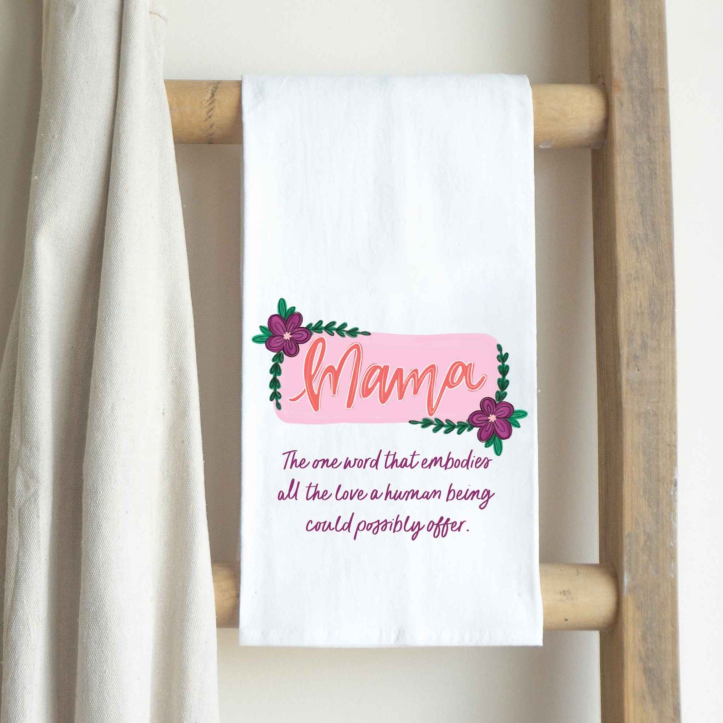 a white towel hanging on a wooden ladder