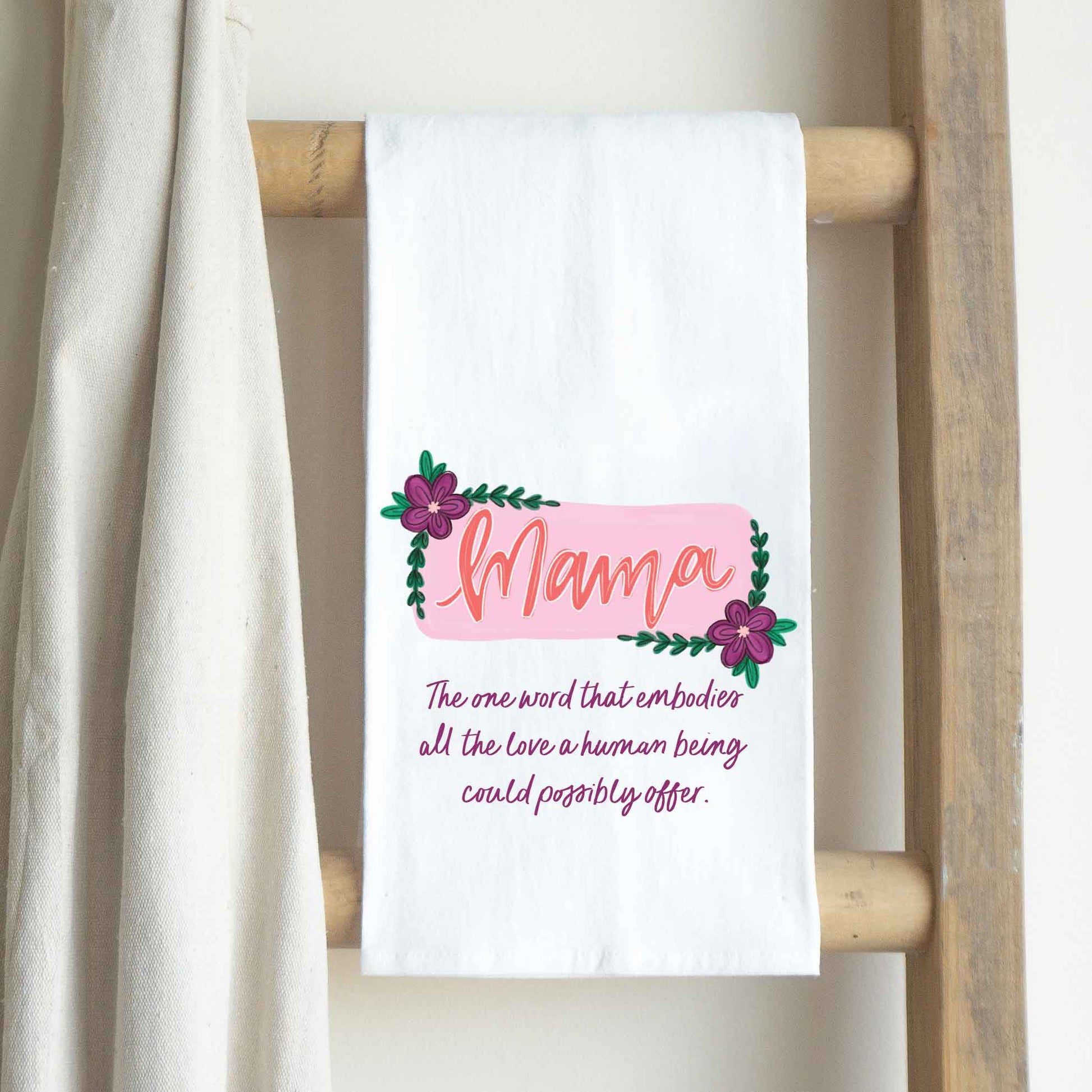 a white towel hanging on a wooden ladder