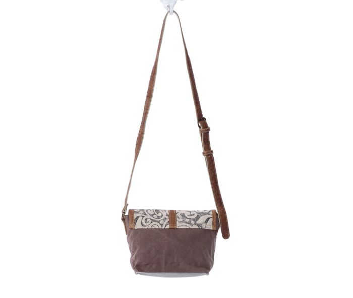 a brown and white purse hanging from a hook