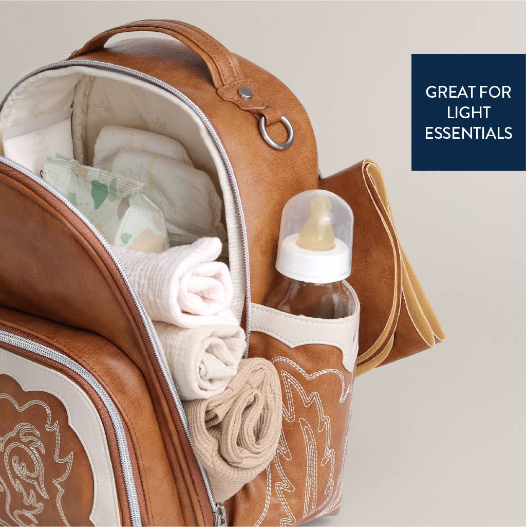 a diaper bag filled with baby items and a bottle of lotion