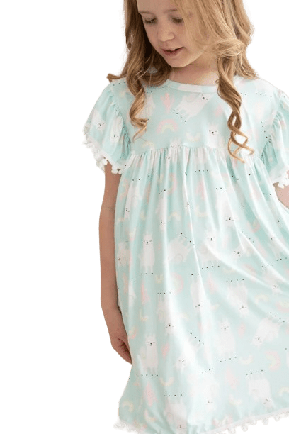 a little girl wearing a blue dress with llamas on it