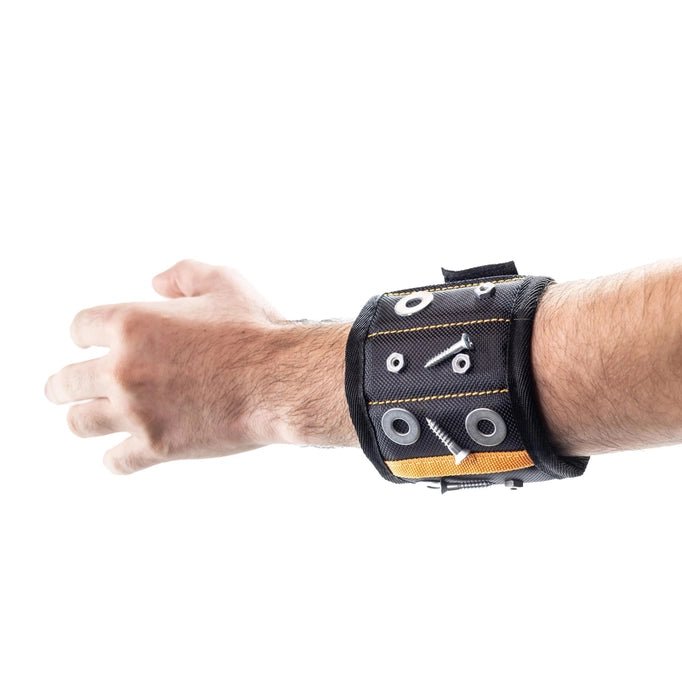 a man's arm with a black magnetic wristband with screws and washers on it