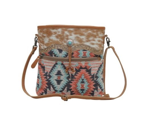 a cross body bag with a multicolored pattern