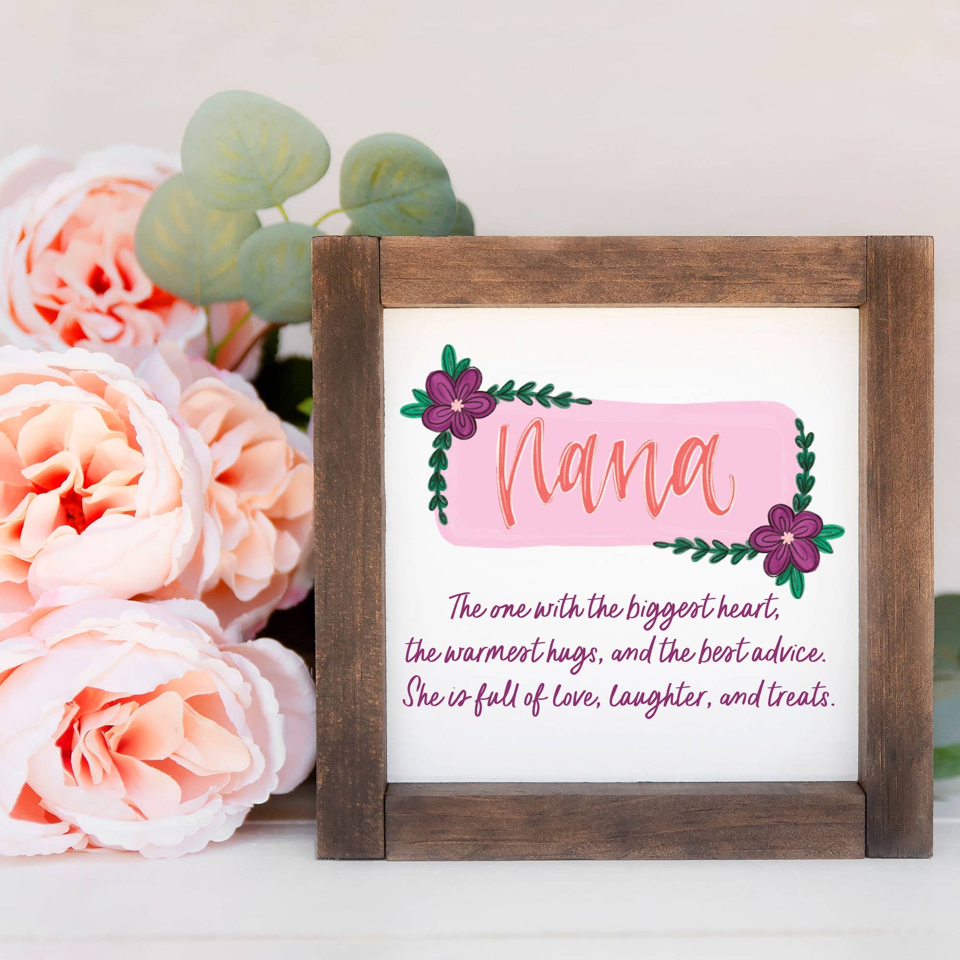 a picture frame with a picture of a flower and a flower arrangement