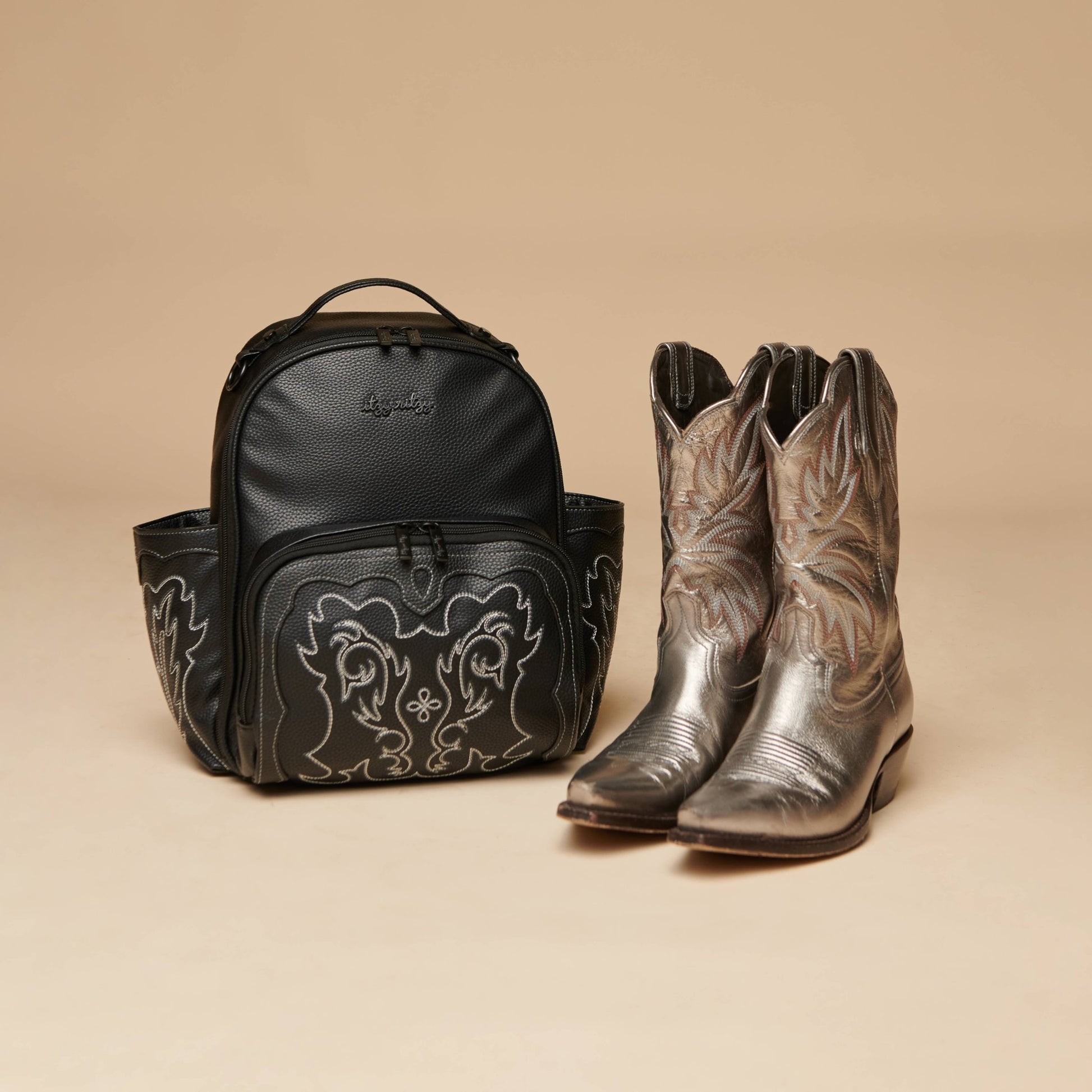 a pair of cowboy boots and a Itzy Ritzy Nash Outlaw Itzy Mini Plus