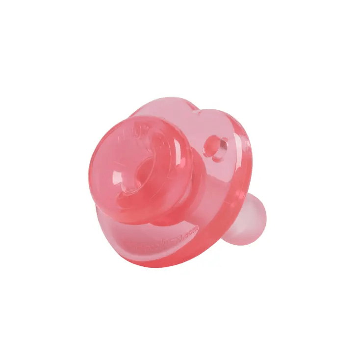 a pink pacifier sitting on top of a white surface