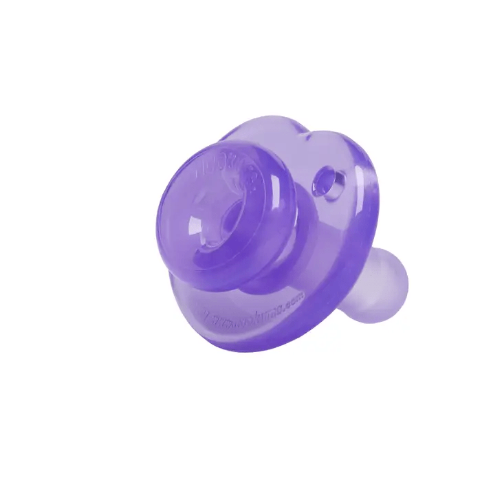 a purple pacifier sitting on top of a white surface