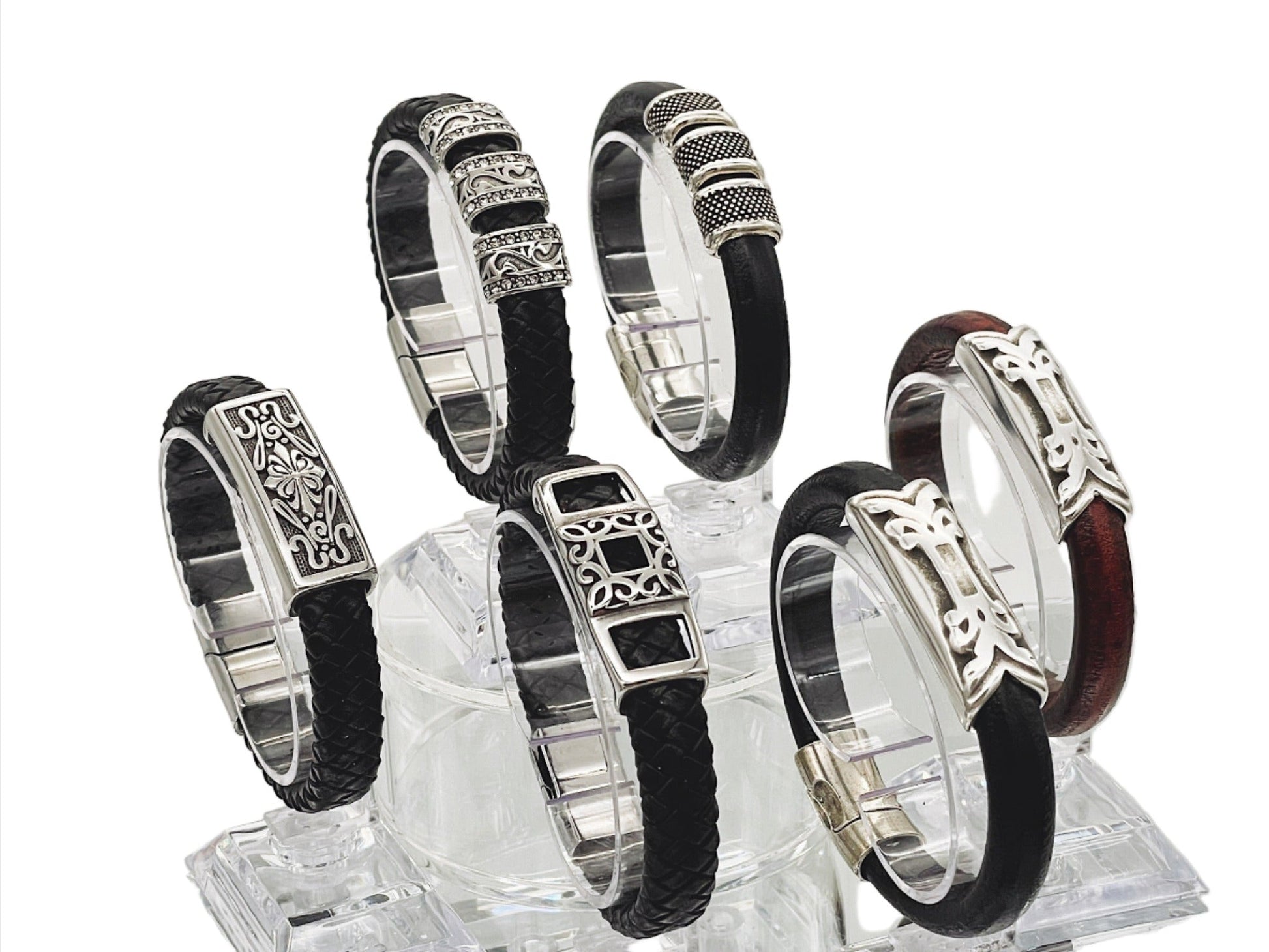 a group of six bracelets sitting on top of a glass block